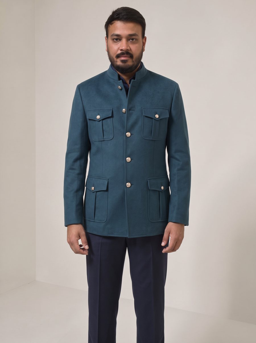 Nitesh Mittal in a teal cashmere band-collar safari jacket with navy trousers