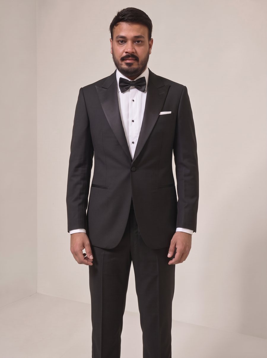 Nitesh Mittal in a black peak-lapel tuxedo with bow tie