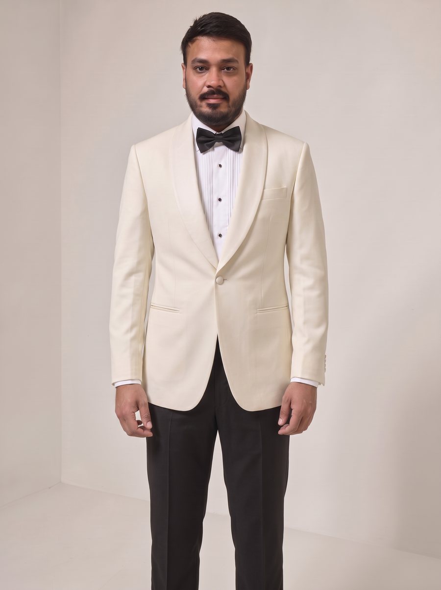 Nitesh Mittal in an ivory shawl-collar dinner jacket with black tuxedo trousers
